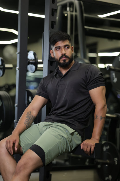 Man lying on a gym machine with weights in the background